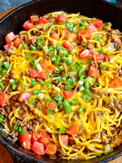 A delicious meal of spaghetti with meat and vegetables.