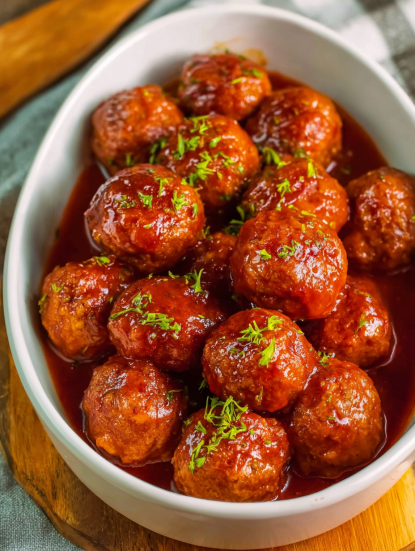 A bowl of meatballs in a brown sauce.
