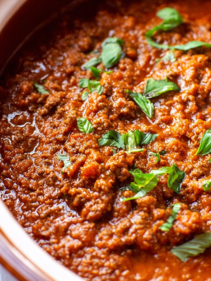 A bowl of chili with green onions.