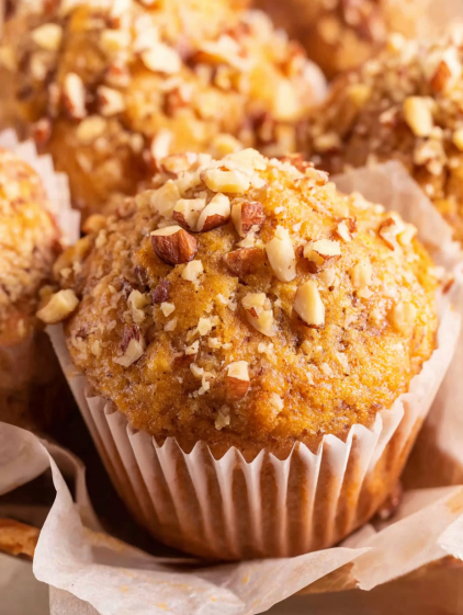 A cupcake with nuts on top.