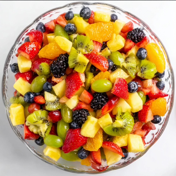 A bowl of fruit salad with strawberries, kiwi, blueberries, and oranges.