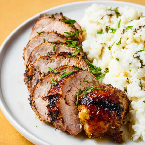 A plate of food with pork and rice.