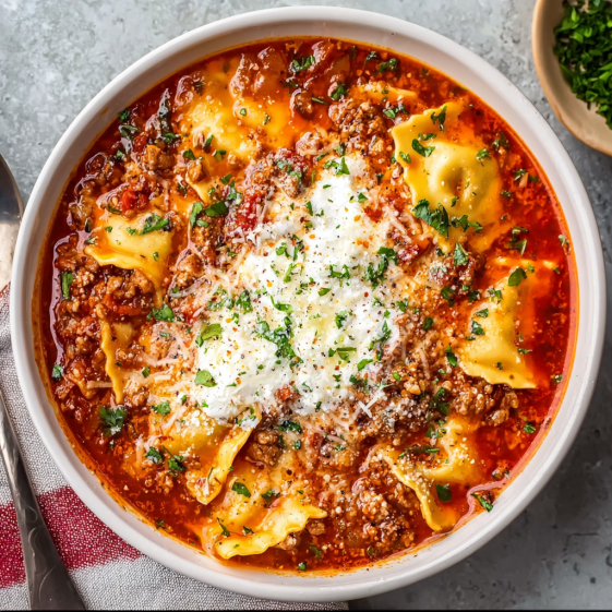 A bowl of pasta with meat and cheese.