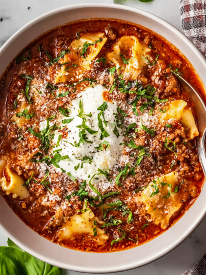 A bowl of pasta with a white sauce.