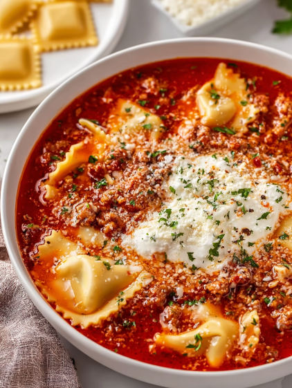A bowl of pasta with a white sauce.