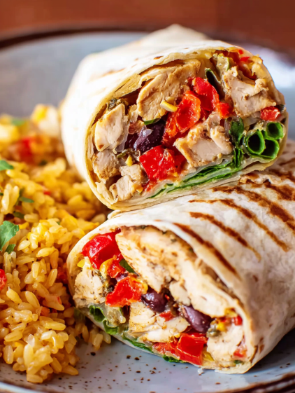 A chicken wrap with rice and vegetables.