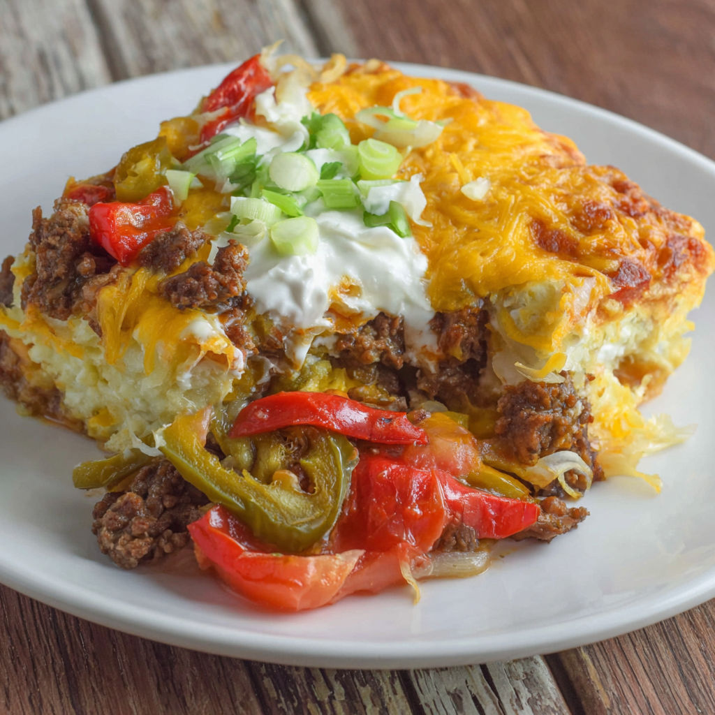 A plate of food with a John Wayne Beef Biscuit.