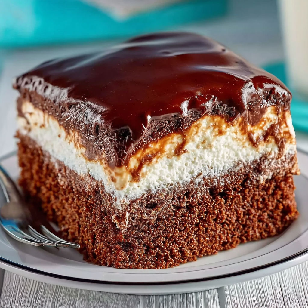 A slice of chocolate cake with white frosting.