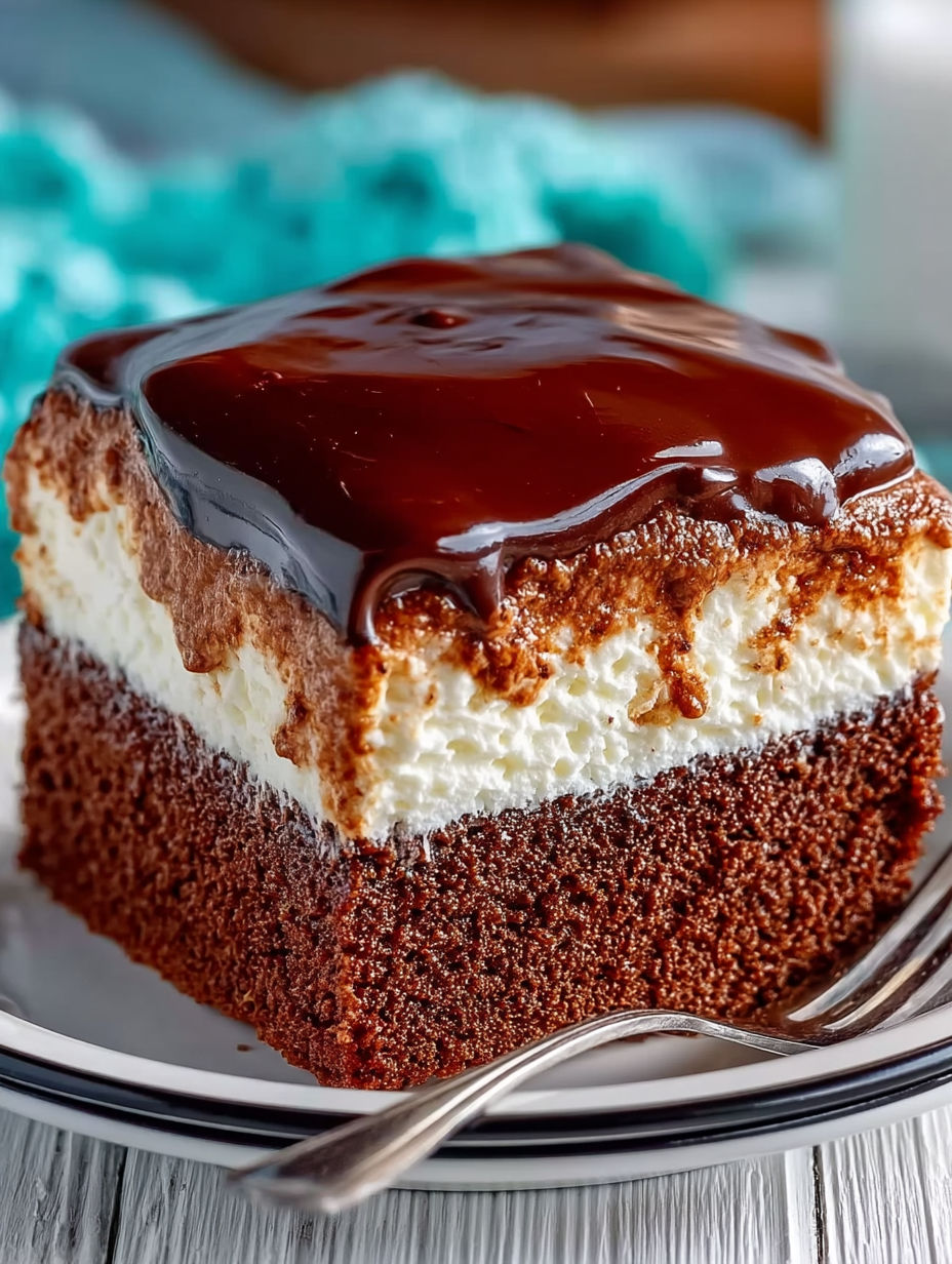 A slice of chocolate cake with white frosting.