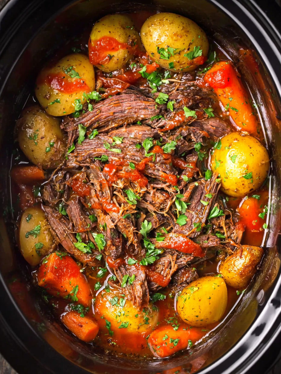 A crock pot filled with Catalina roast beef and potatoes.