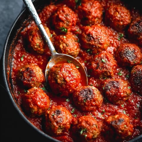 A bowl of meatballs in a tomato sauce.