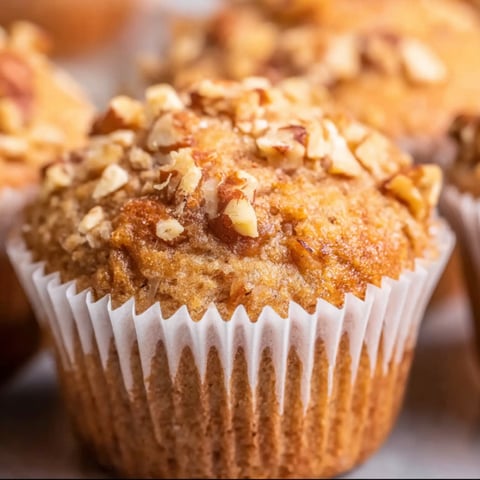 A muffin with nuts on top.