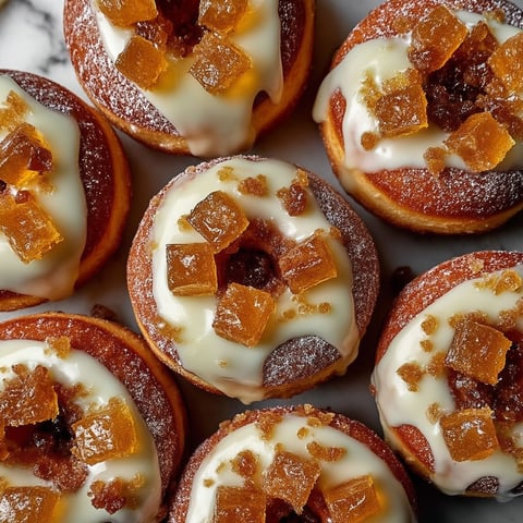 A plate of donuts with a glaze and sugar topping.