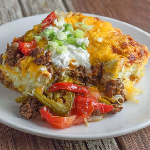 A plate of food with a John Wayne Beef Biscuit.