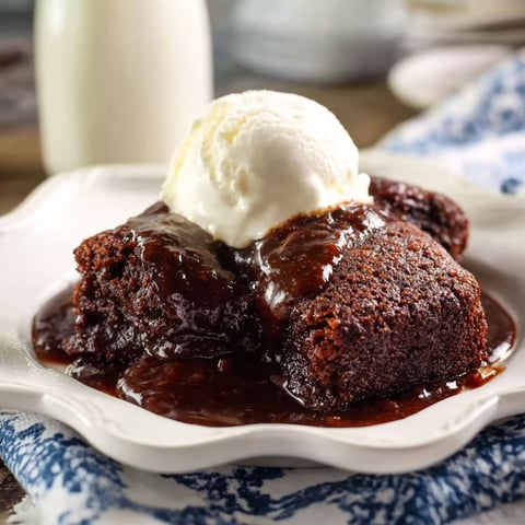 A plate of chicken étouffée with a scoop of ice cream on top.