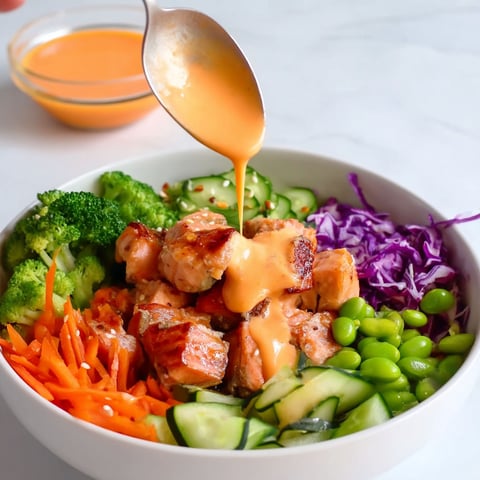 A bowl of food with a spoon in it.