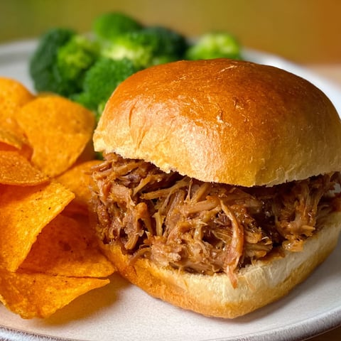 A sandwich with pulled pork on a bun.